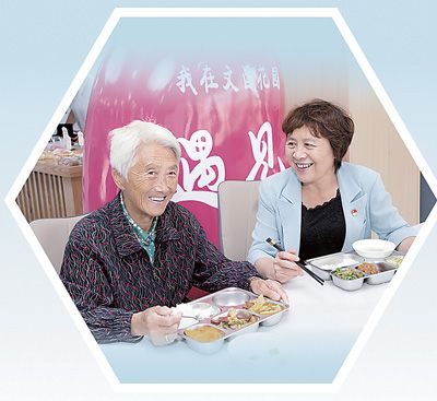 鄭翔（右）在社區(qū)食堂征詢居民意見建議。程可欣攝